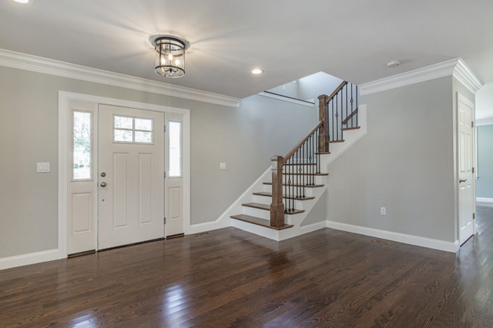Hardwood floor entryway with view of L-Shaped staircase