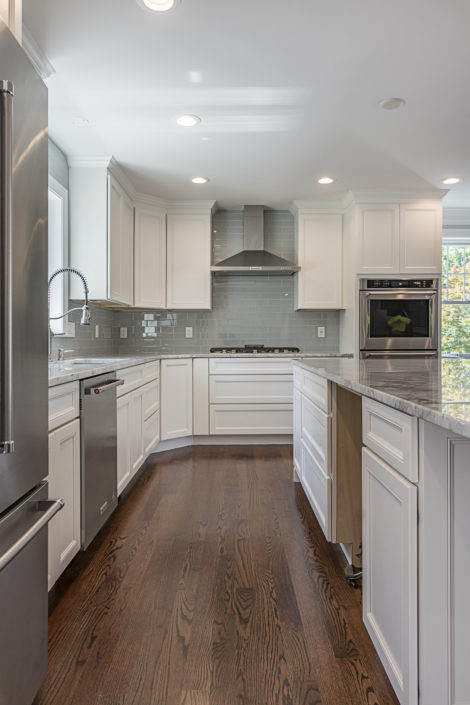 Kitchen with quartz countertops, stainless steel appliances and hardwood flooring