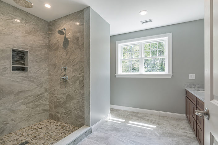 Custom bathroom with spacious built-in shower and countertop sinks
