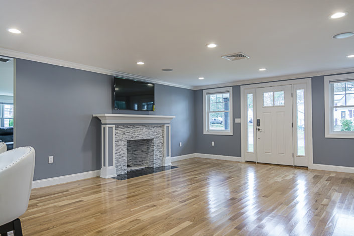 Large entryway with custom fireplace and mounted television