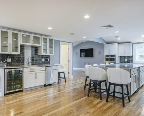 Hardwood floor kitchen with large middle island, plenty of seating and a custom designer feel